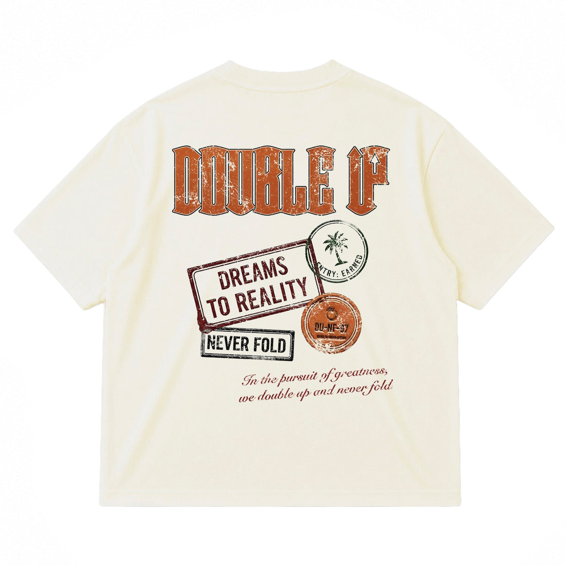 An off-white short-sleeve t-shirt shown from the back, featuring a large graphic print with the words 'DOUBLE UP' in distressed orange lettering, a stamp reading 'DREAMS TO REALITY', and other vintage-style design elements.