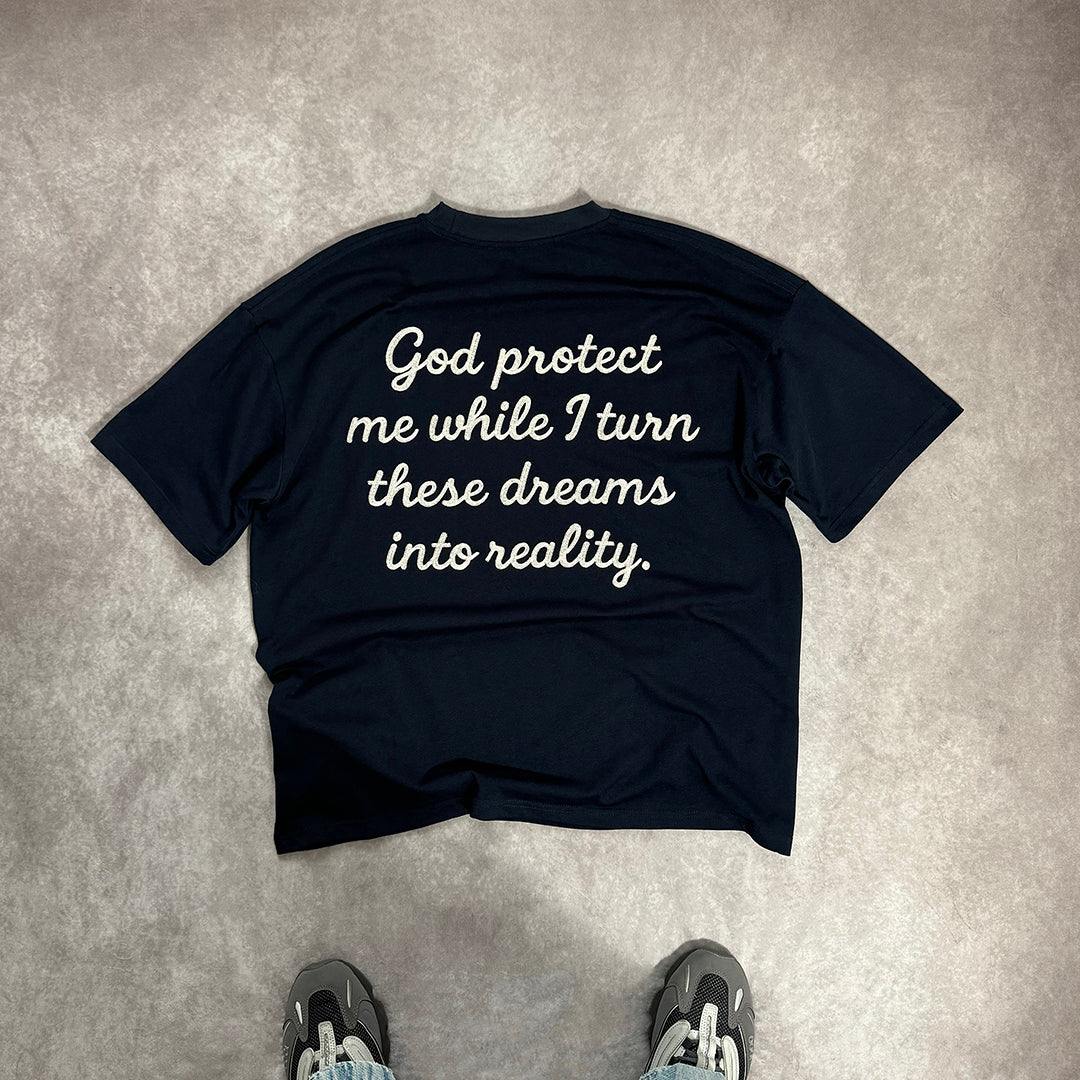 Black t-shirt with motivational quote on a gray surface