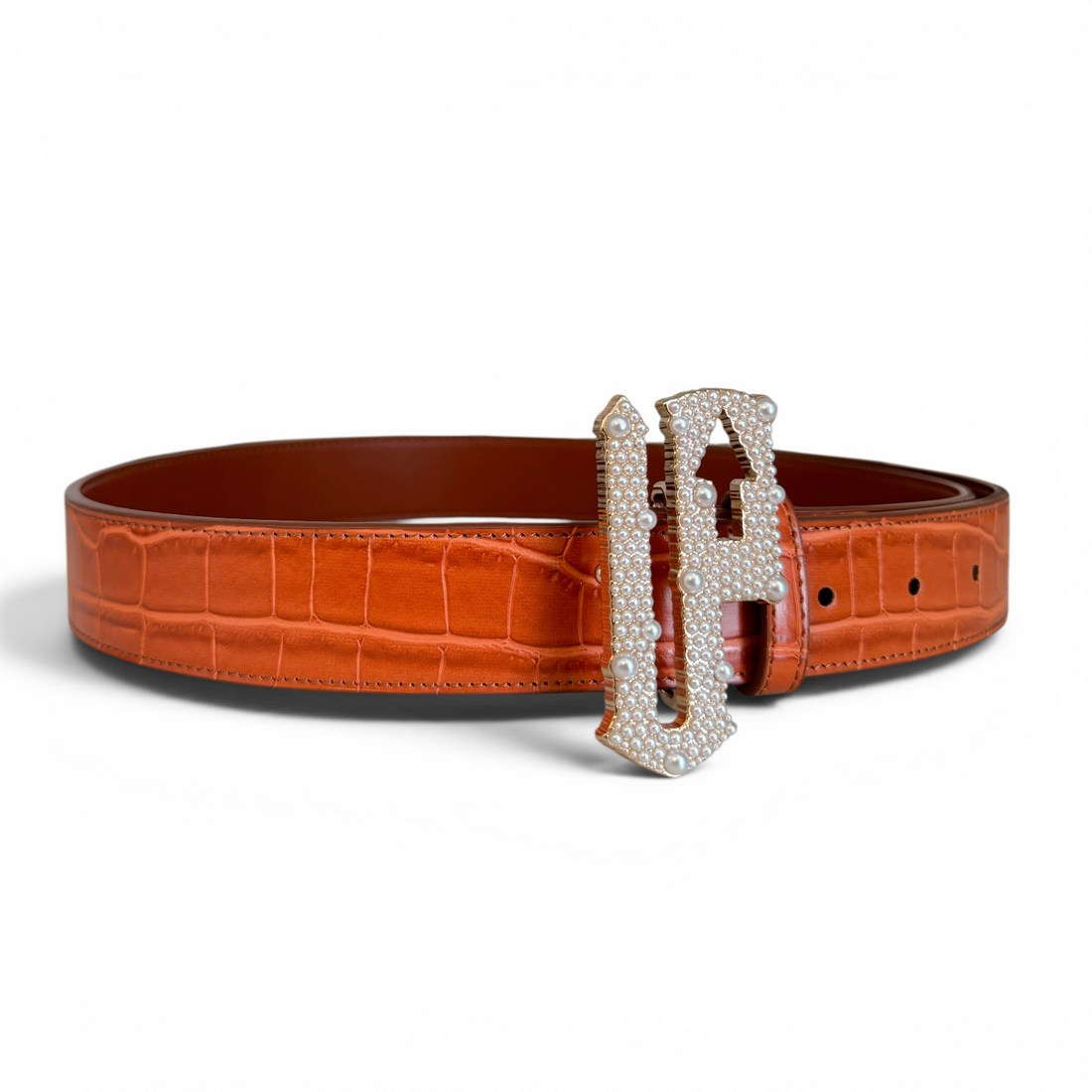 Brown crocodile-patterned belt with a decorative silver buckle on a white background